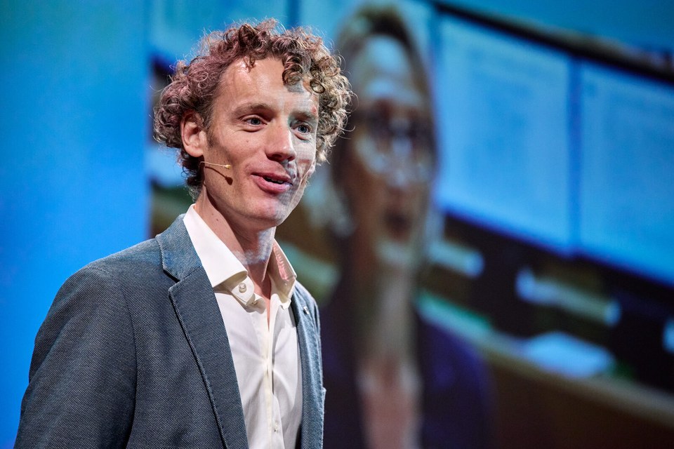 Laurens Waling op het podium voor een groot scherm